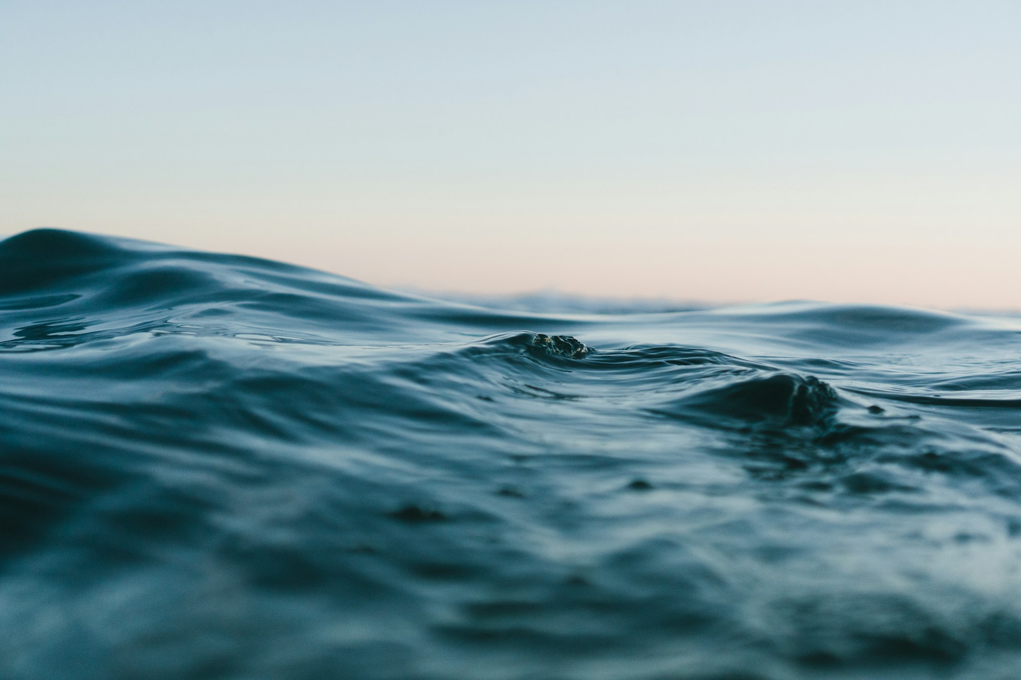 Quiet ocean waves catching the last light